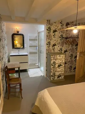 a bedroom with a bed and a sink and a television at Le Mas Carradou , Mas de Prestige en campagne in Monteux