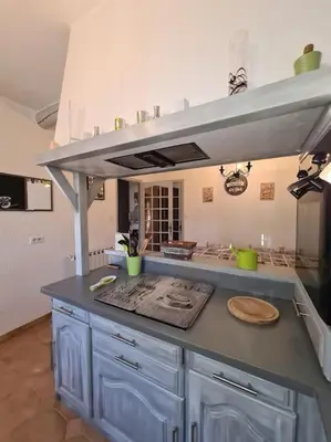a kitchen with blue cabinets and a counter top at La Villa St Antoine in LʼIsle-sur-la-Sorgue