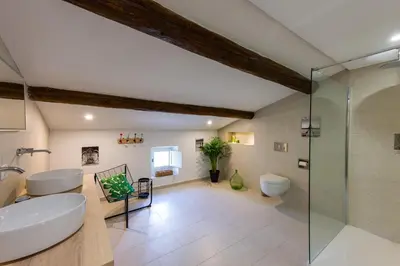 a bathroom with a glass shower and a sink at Mas authentique à Eygalières in Eygalières