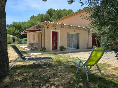 two lawn chairs sitting in front of a house at Gîte l'olivier in Sainte-Tulle