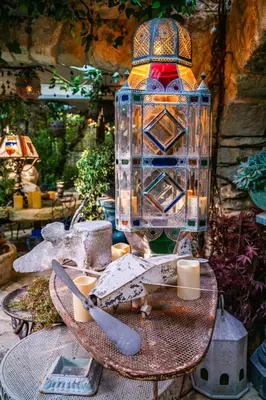 a glass jar with a candle on a table at L'unique in Goult
