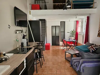 a kitchen and a living room with a couch at Appartement à La Bastidonne in La Bastidonne