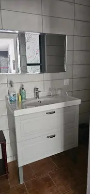 a bathroom with a white sink and a mirror at Appartement à La Bastidonne in La Bastidonne