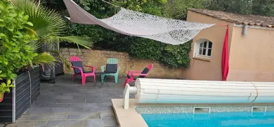 a patio with chairs and a table next to a pool at Appartement à La Bastidonne in La Bastidonne