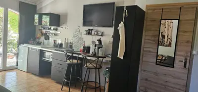 a kitchen with a counter and a table in it at Appartement à La Bastidonne in La Bastidonne