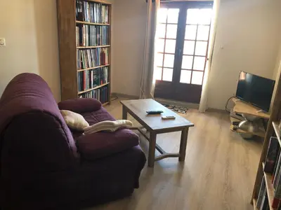 a living room with a couch and a coffee table at La Respelido studio ds maison campagne in Cabannes