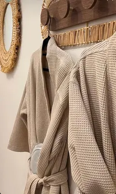 a sweater hanging on a rack with a mirror at Le Mas d'Emilienne in Coudoux