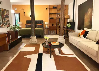 a living room with a couch and a table at La Cigalou - Bonnieux Centre in Bonnieux