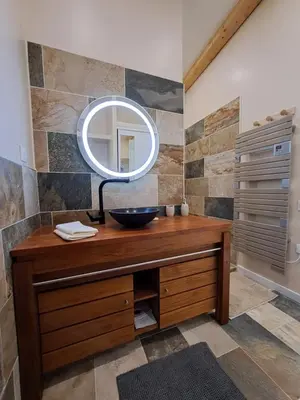 a bathroom with a sink and a mirror at La Pinède de Venelles Jacuzzi privatif in Venelles