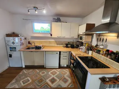a kitchen with white cabinets and a counter top at Le Mazet des Beaujots in Monteux