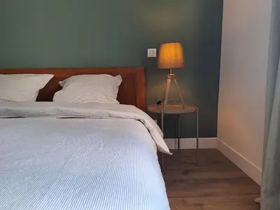a bedroom with a bed and a table with a lamp at Mas Les Figuières in Monteux