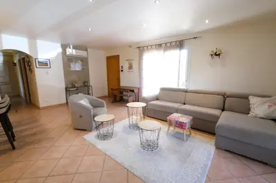 a living room with a couch and a table and chairs at Air-conditioned house with heated pool, Luberon, in Maubec – 6 people in Maubec