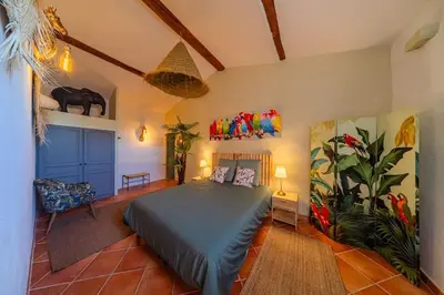 a bedroom with a bed in a room at Ancien Moulin avec piscine proche Isle-sur-Sorgue in Le Thor