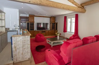a living room with red chairs and a table at superb prestige property with indoor heated swimming pool, seminar room and tennis court in mouries, in the alpilles in provence – 16 people in Mouriès
