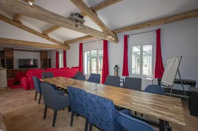 a large room with a wooden table and chairs at superb prestige property with indoor heated swimming pool, seminar room and tennis court in mouries, in the alpilles in provence – 16 people in Mouriès