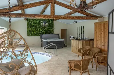 a room with a tub and a table and chairs at superb prestige property with indoor heated swimming pool, seminar room and tennis court in mouries, in the alpilles in provence – 16 people in Mouriès
