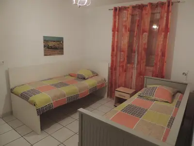 a bedroom with two beds and a window at Villa au calme in Eyguières