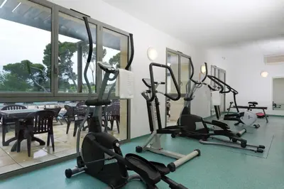 a gym with several exercise bikes in a room at Gîte Confortable Vue Exceptionnelle - Golf de Saumane in Saumane-de-Vaucluse