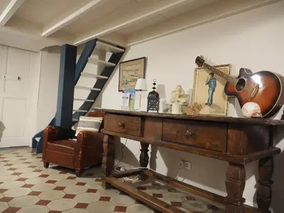 a hallway with stairs and a table and chairs at Bed and Breakfast Jardin de Marie in Aix-en-Provence