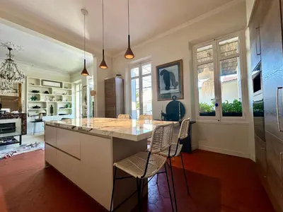 a kitchen with a large island with chairs in it at Divine Idylle Luxe 3 chambres, terrasse 130m2, jacuzzi, Clim 5 m Cours Mirabeau in Aix-en-Provence