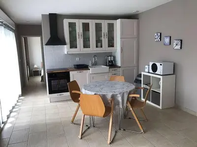 a kitchen with a table and chairs in a room at Gite de charme avec piscine dans le Luberon in Cavaillon