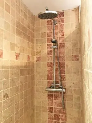 a shower with a shower head in a bathroom at Gite de charme avec piscine dans le Luberon in Cavaillon