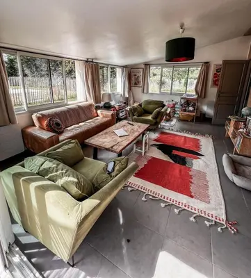 a living room with a couch and a table at Maison de charme provençale en pierre in Puyvert