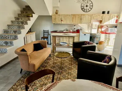 a living room with couches and a kitchen at L' Escale in Bonnieux