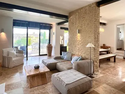 a living room with a couch and a table at Le Clos de Yann in Gordes