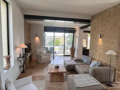 a living room with a couch and a table at Le Clos de Yann in Gordes