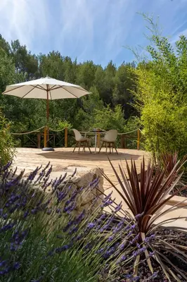 a table and two chairs under an umbrella at Juste en Provence in Saint-Saturnin-les-Apt