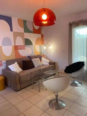 a living room with a couch and a table at Inspiration maison entière avec jardin in Pernes-les-Fontaines