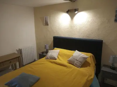 a bedroom with a yellow bed with two pillows at Chambres d'hôtes L'Amphitryon 5 CHAMBRES in Villemus