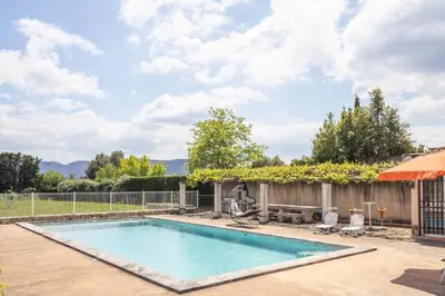 a swimming pool in a yard with a fence at Le Petit Nid in Saint-Rémy-de-Provence
