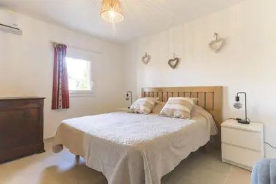 a bedroom with a bed with two pillows and a window at Le Petit Nid in Saint-Rémy-de-Provence