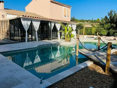 a swimming pool in front of a house at L'Apt Tropez in Apt