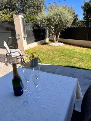 a table with two wine glasses and a bottle on it at La Villa Rustica in Aix-en-Provence