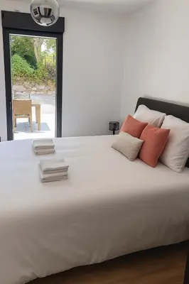 a large white bed with four pillows on it at La Villa Rustica in Aix-en-Provence