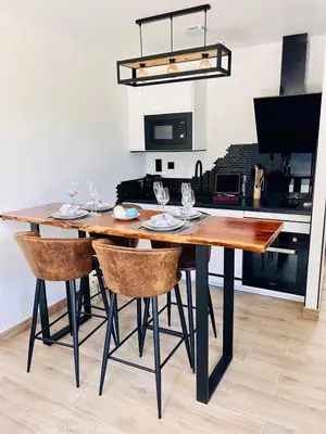 a dining room table with chairs and a kitchen at La Villa Rustica in Aix-en-Provence