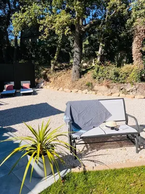 a lounge chair with a blanket on it next to a plant at La Villa Rustica in Aix-en-Provence