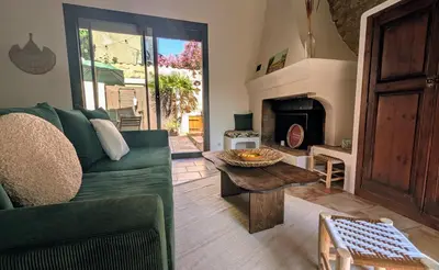 a living room with a couch and a table and a fireplace at Charming & medieval village house completely renovated with great exterior and views in Mallemort
