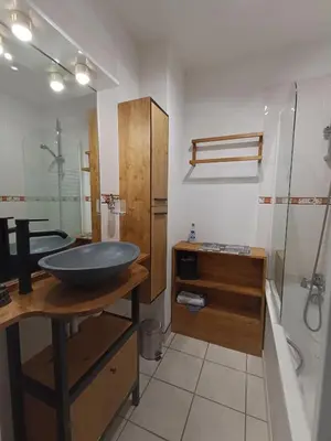 a bathroom with a sink and a shower and a tub at Maison provençale avec piscine partagée in Loriol-du-Comtat