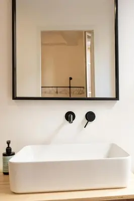 a white sink in a bathroom with a mirror at Mistral126 in Aix-en-Provence