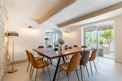 a dining room with a wooden table and chairs at Oasis de Gordes in Gordes