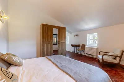 a bedroom with a bed and a living room at Oasis de Gordes in Gordes