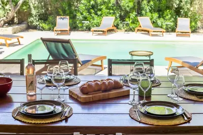 a table with wine glasses and a tray of food at Oasis de Gordes in Gordes