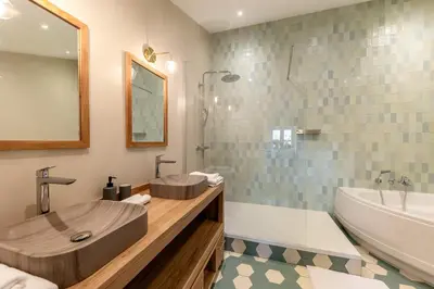 a bathroom with a tub and a sink and a bath tub at Oasis de Gordes in Gordes