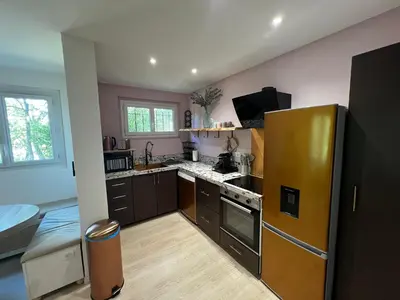 a kitchen with a stainless steel refrigerator in a room at Gîte de charme pour 6 personnes à Apt in Apt