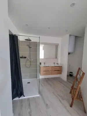 a bathroom with a glass shower and a sink at Maison de village avec terrasse in Grans