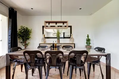 a dining room with a table and chairs at Les Hauts de Provence - Maison avec piscine in Aix-en-Provence